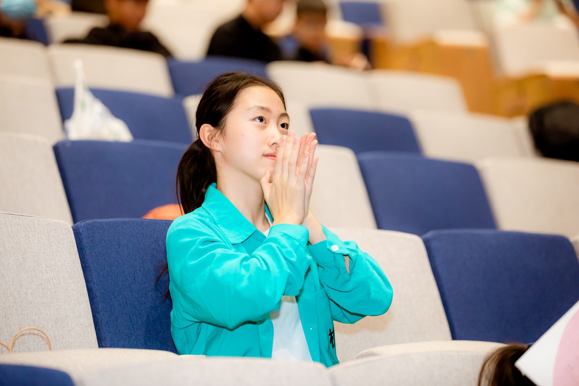 Qingci Song surrounded by cherry blossoms
